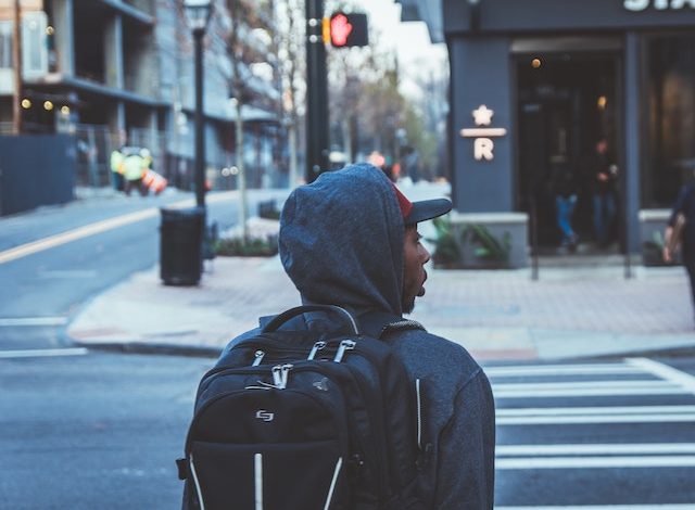 digital nomad walking in city with backpack