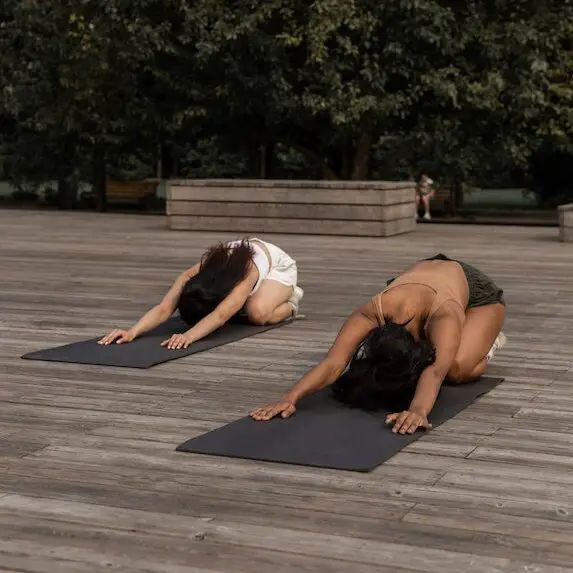 two women doing Childs pose yoga