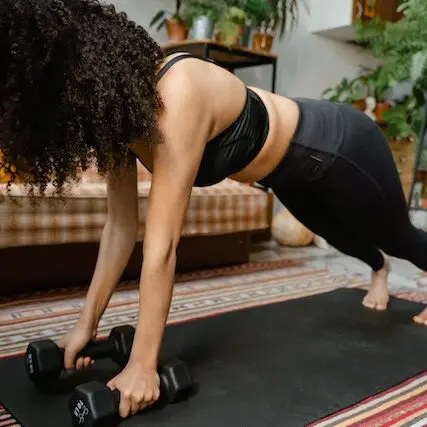woman doing a push-up in a living room